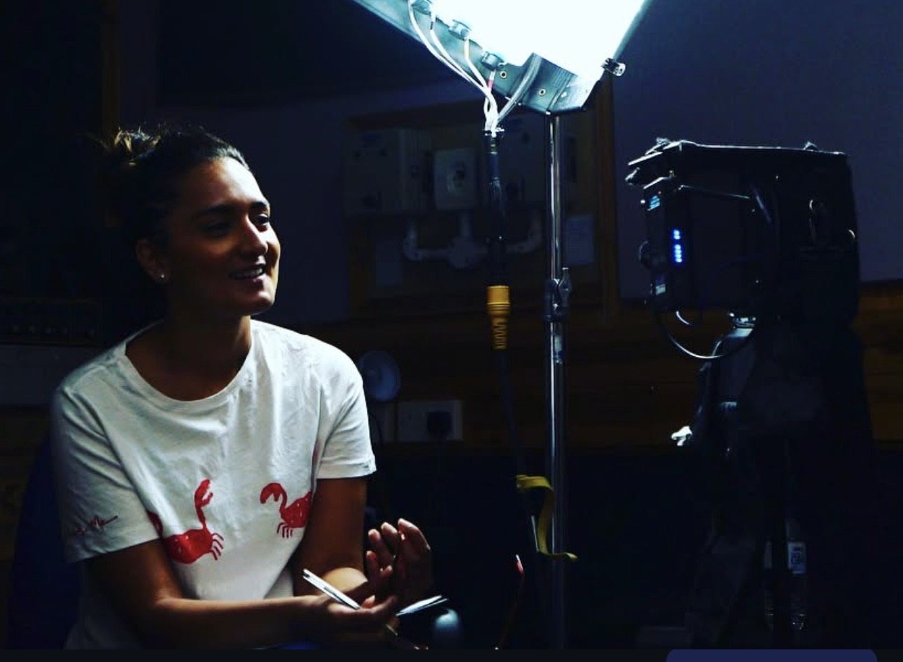 Maleena directing an interview on set
